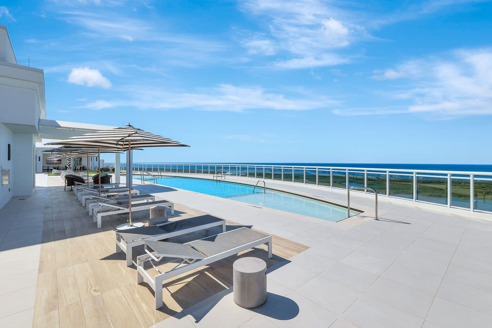 Kalea Bay rooftop pool deck with chaise lounges overlooking the Gulf of Mexico