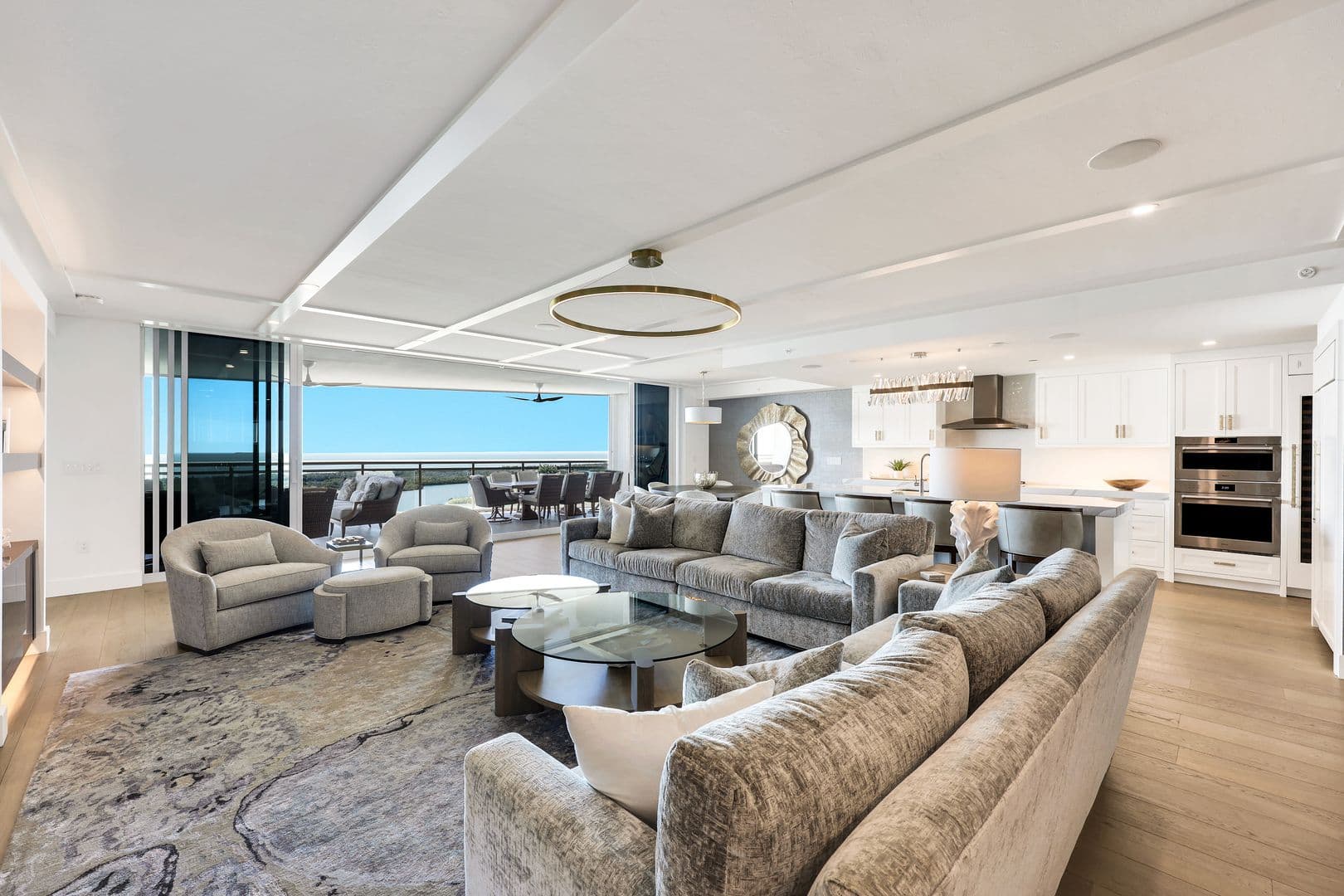 Kalea Bay residence great room with floor-to-ceiling windows framing the Gulf of Mexico